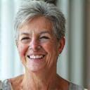 Smiling woman in her late 40s, exuding calm and happiness.